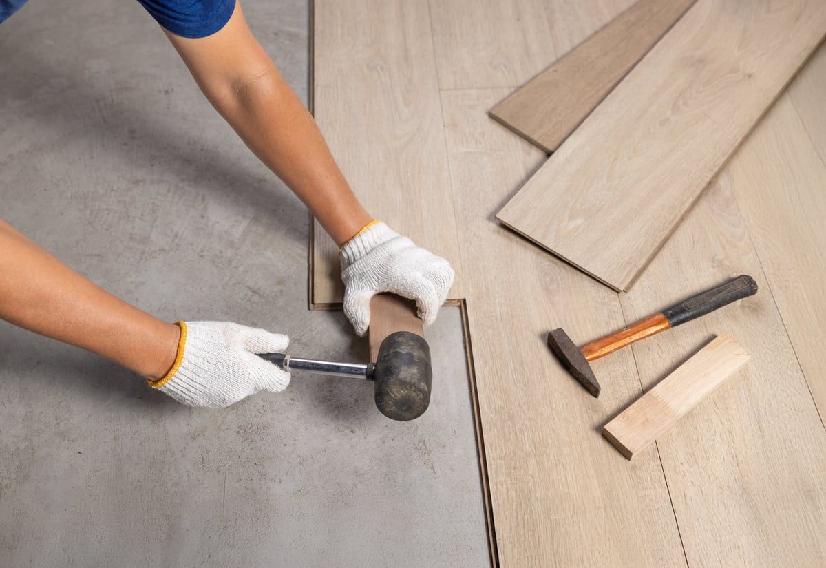 Worker installing laminate flooring