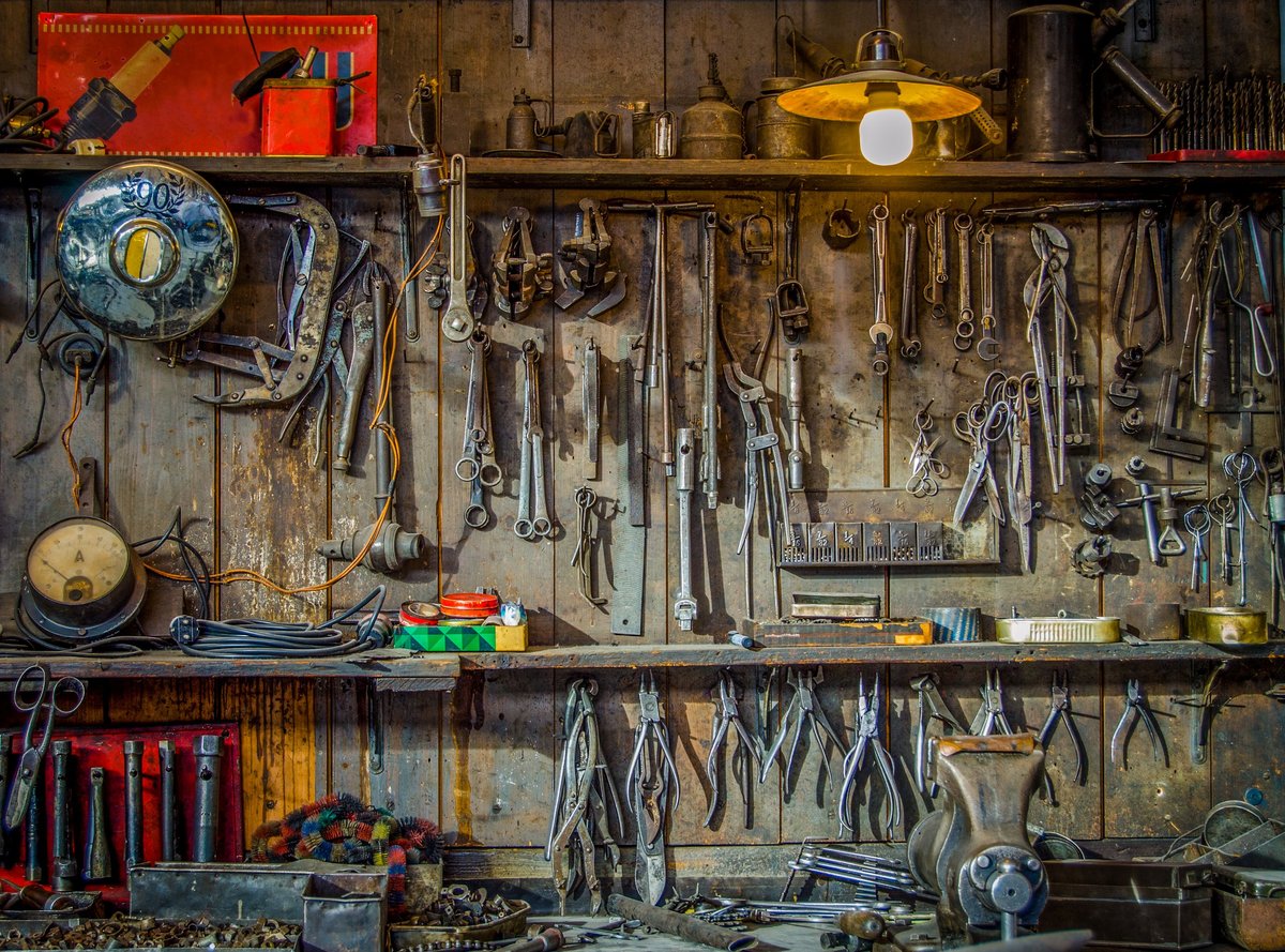 Vintage tools hanging on a wall in a workshop
